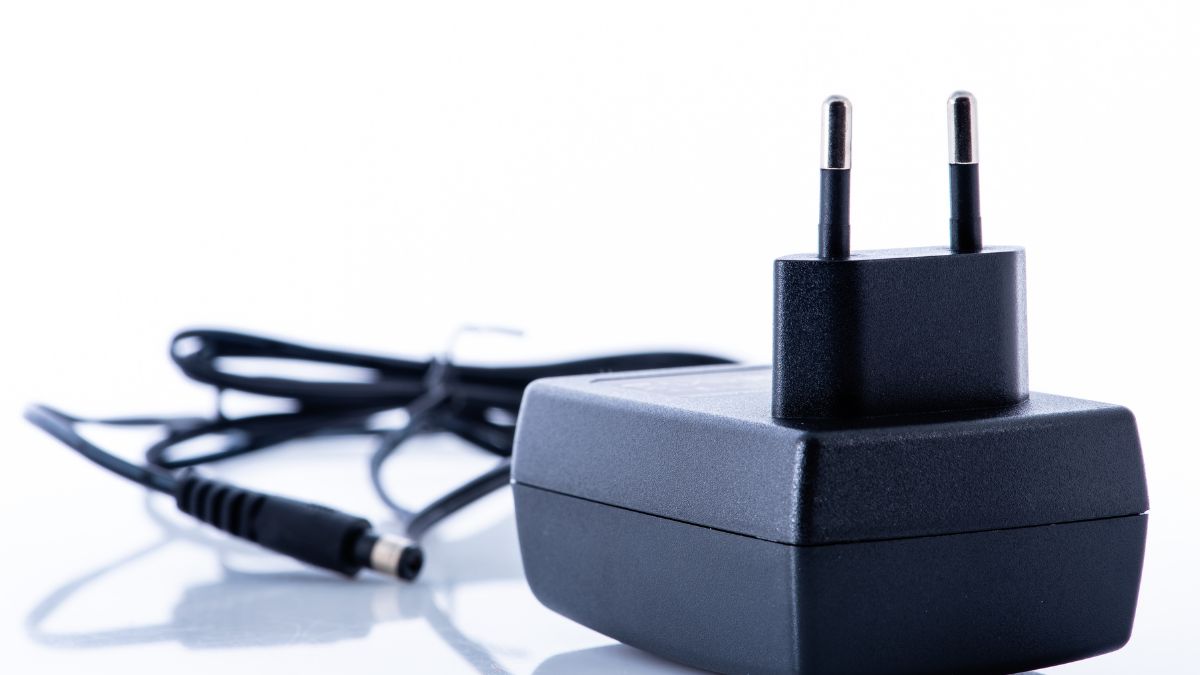 Čierny DC-DC menič s dvoma kolíkmi a káblom, určený na napájanie elektronických zariadení.